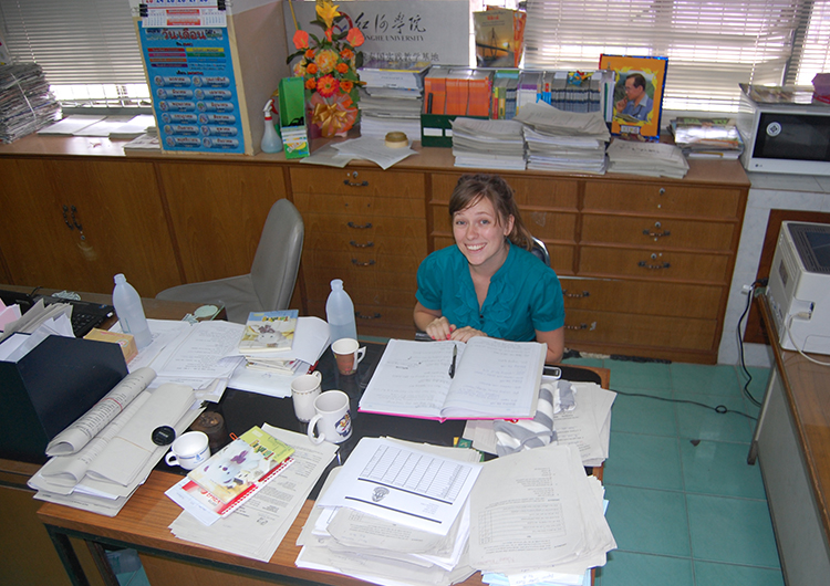 An English teacher at a desk in Thailand.