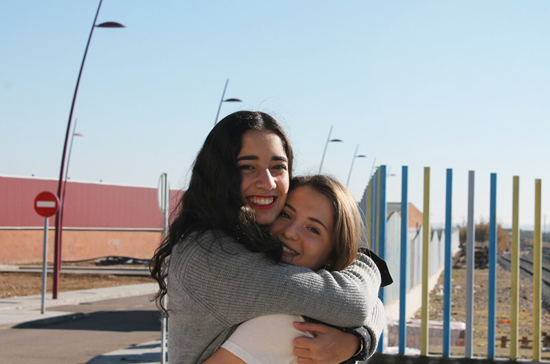 Two friends embracing in Spain.