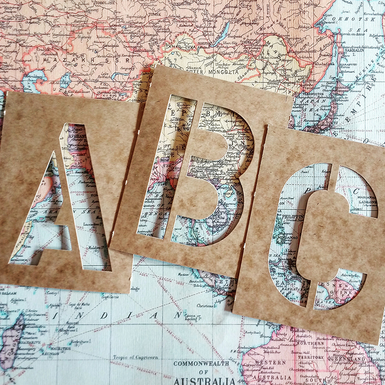 ABC stencil letters of a world map.