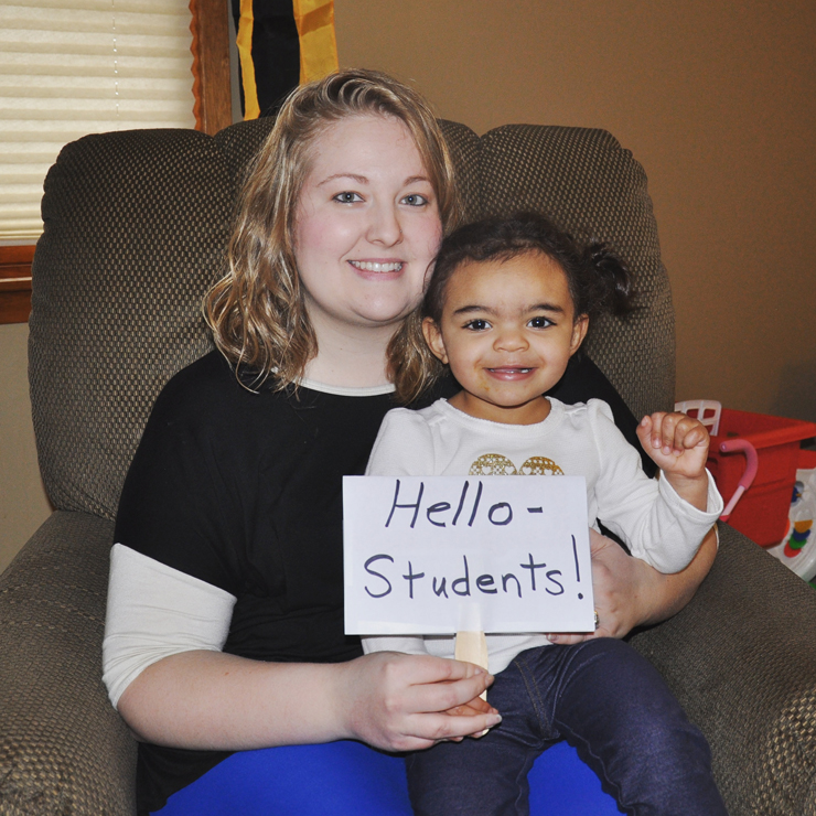 A teacher abroad's sister and niece greetings his students.