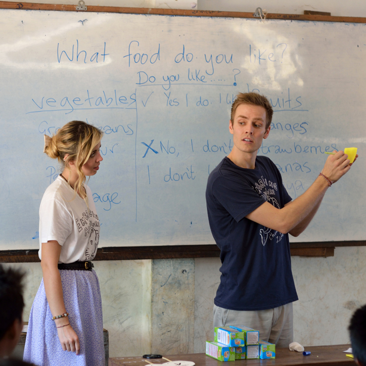 Friends teaching together in a classroom in Myanmar.