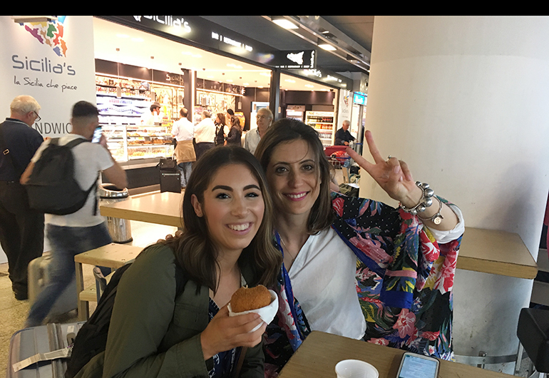 Two women with food in Italy.