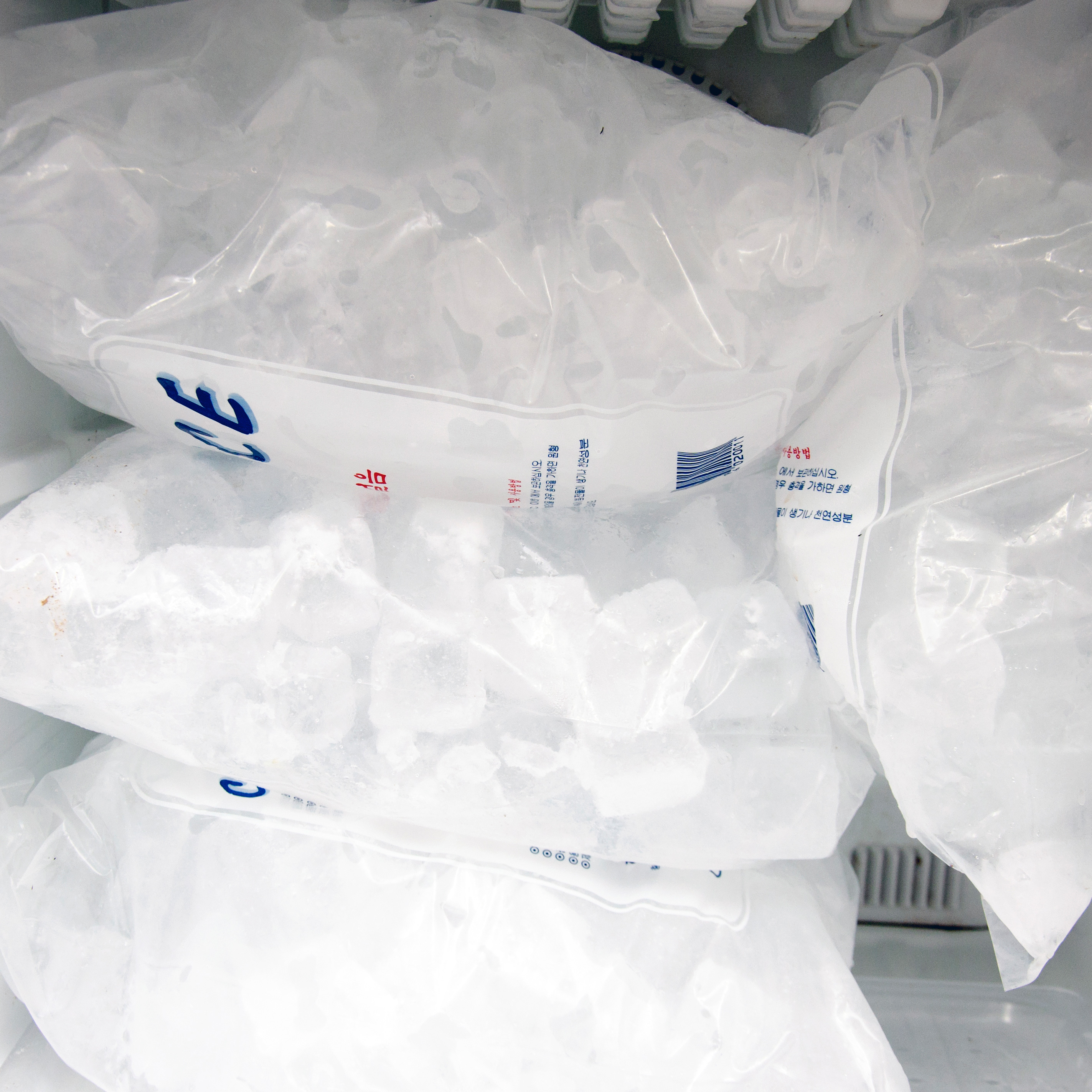 Bags of ice in a freezer.