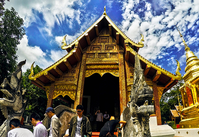 People visiting a temple in Thailand.
