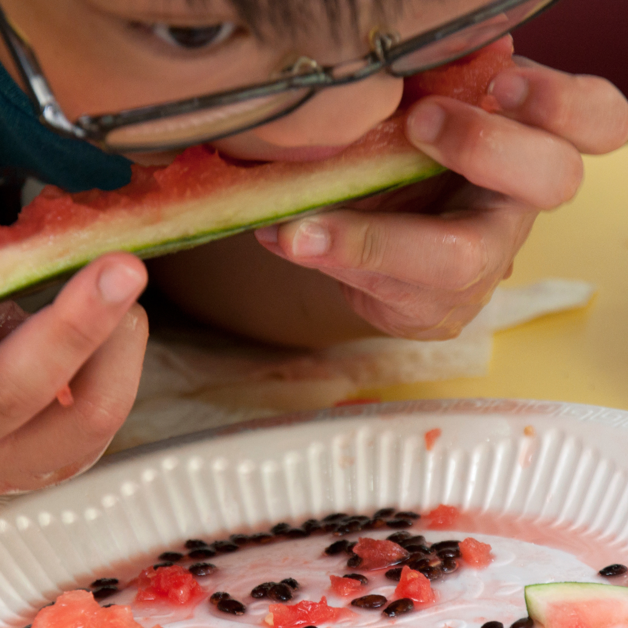 A student bites watermelon in the summer.