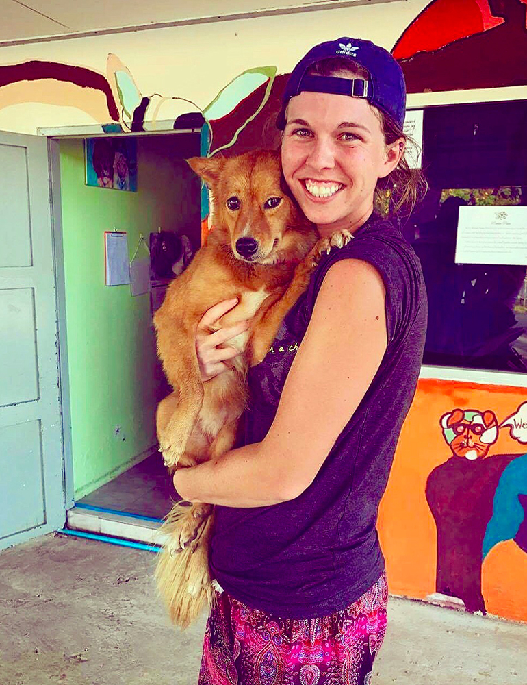 Greenheart Traveler, Lindsay Kurz, with a rescued dog in Thailand.
