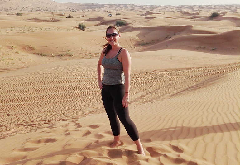 Greenheart Traveler, Krystal Rogers, traveling solo in a desert.