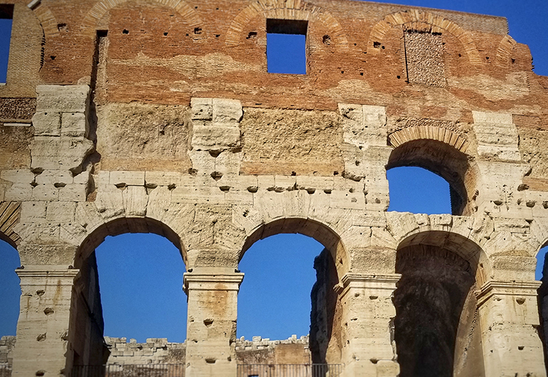 Rome's Colosseum on a bright, sunny day. Photo by Greenheart Traveler Susan LacCanne.