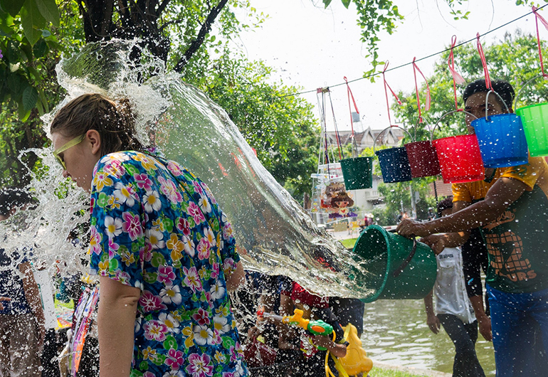 Water being tossed with a bucket during Songkran in Thailand.