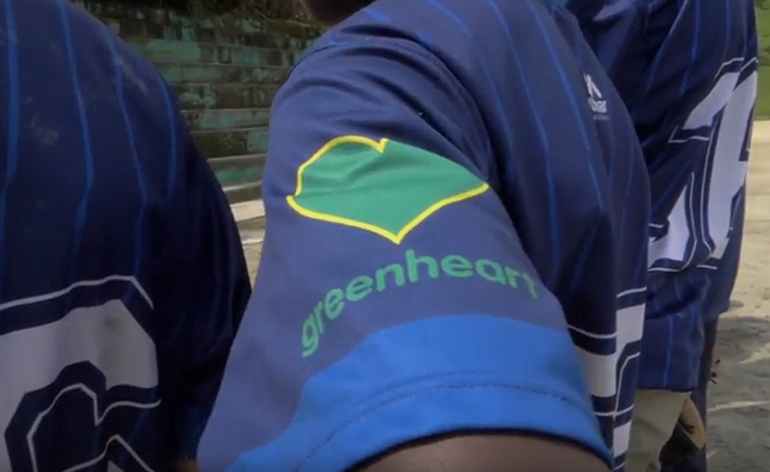 A Greenheart logo on a baseball jersey.