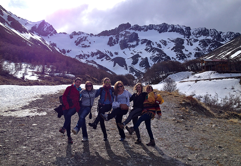 Students posing in front of the snowcapped mountains in Argentina.