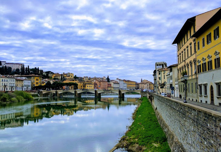 The Arno River in Florence, Italy on a cloudy day.