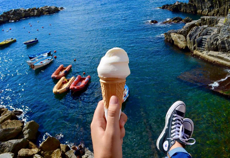 A gelato over the cliffs of Cinque Terre with the sea below.