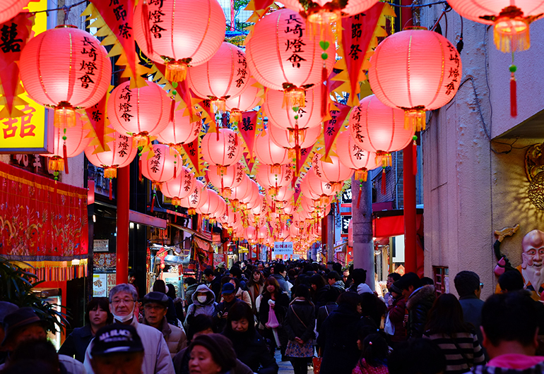 A latern festival lining the street in Japan at night.
