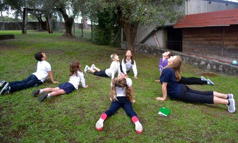 A circle of students doing a stretching activity.