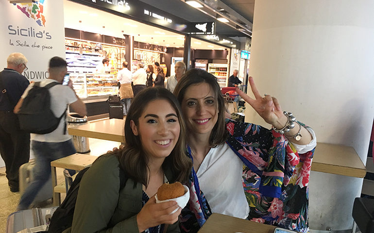 Two women with food in Italy.