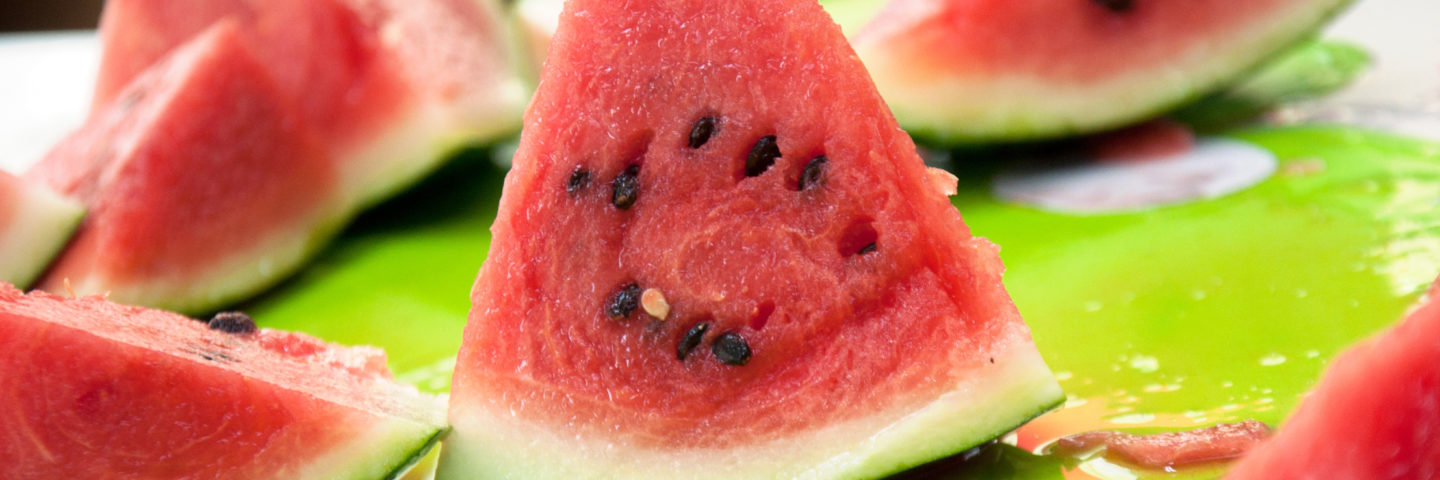 Slices of watermelon on a cutting board.