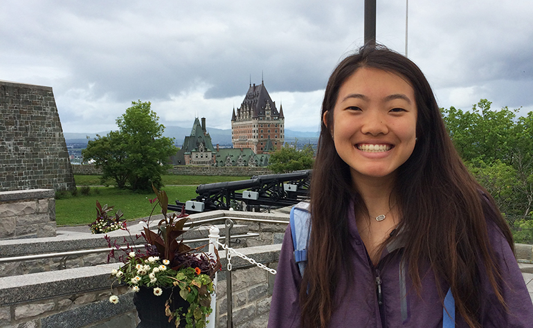 A Greenheart Traveler in front of Rachel Shen in Quebec City with Château Frontenac behind her..