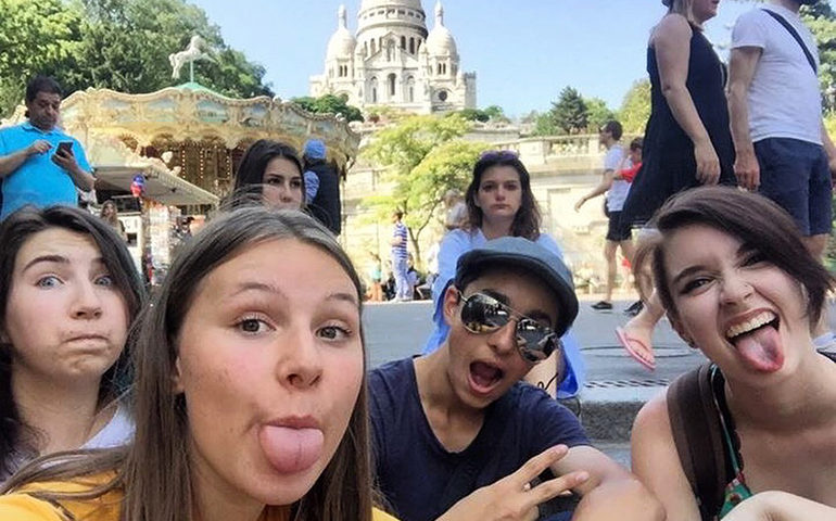 A group photo in front of the Sacre Coeur in Paris, France.