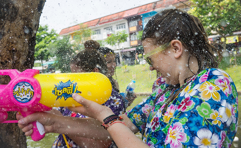 Celebrating Songkran in Thailand with water guns.