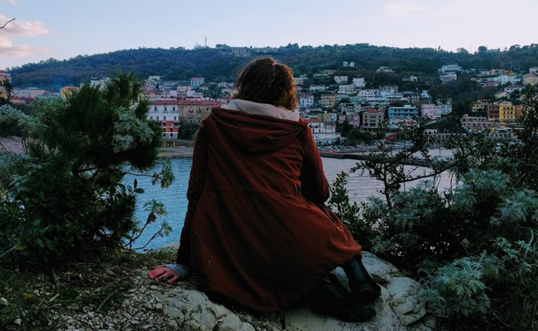 Mikaela looking over the sea and builidngs in Sorrento, Italy.