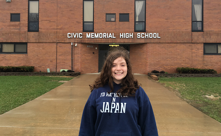 Emily outside of her high school getting ready to go to Japan.